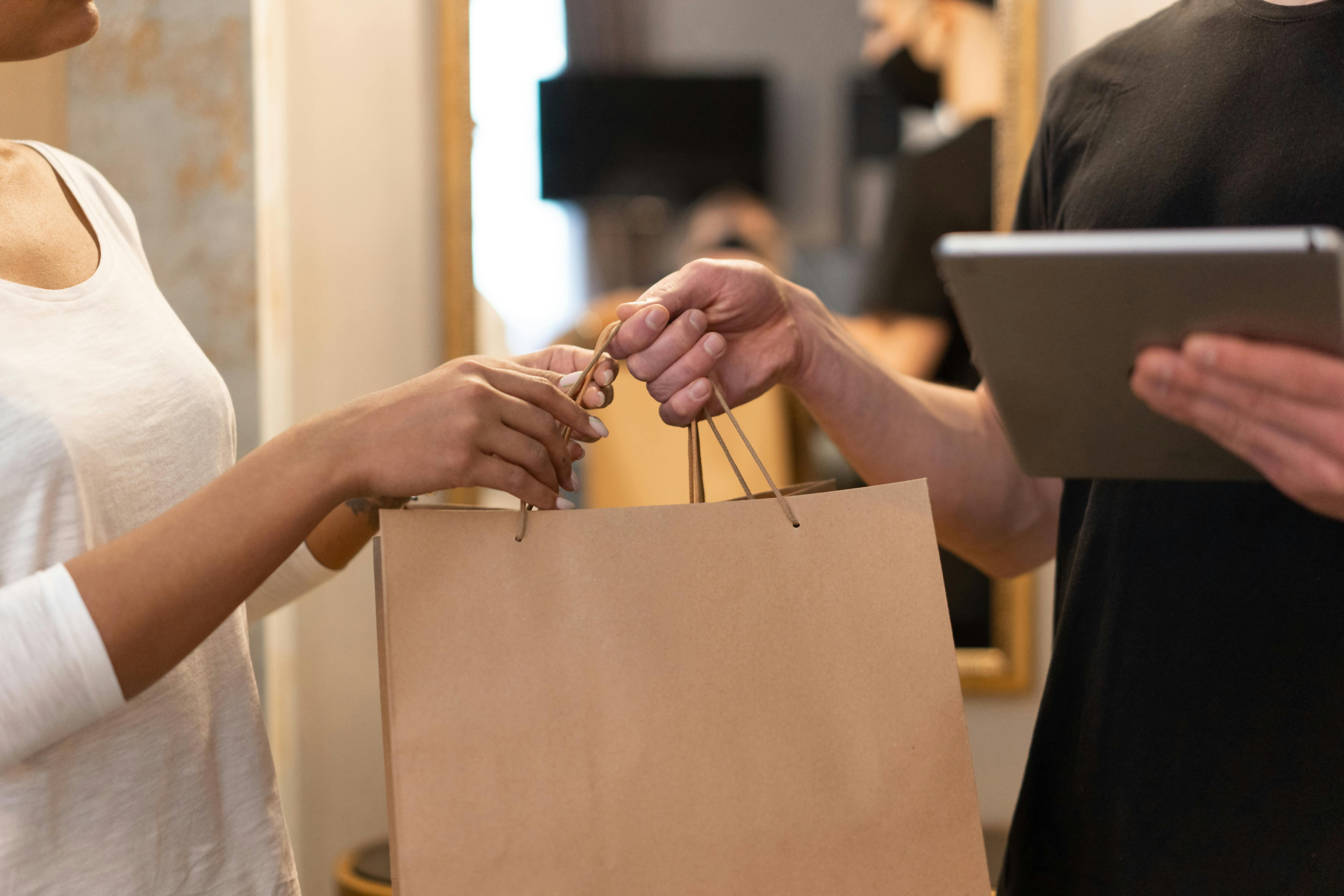 Customer receiving shopping bag from online store